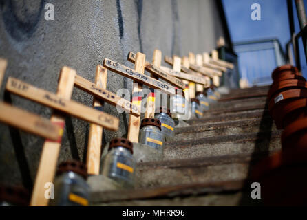 03 May 2018, Germany, Duisburg: Wooden crosses are placed on a stairway of the memorial for the 21 victims of the Loveparade. On 24 July 2010 21 young people died in a scramble during the techno parade. Photo: Ina Fassbender/dpa Stock Photo