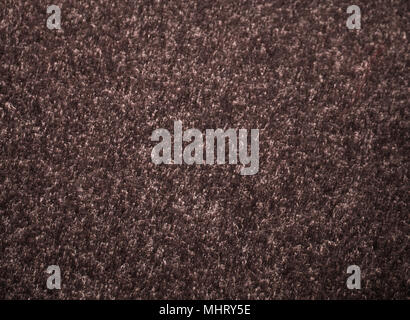 Brown fabric carpet, fragment of texture, pattern of carpet. Background Stock Photo