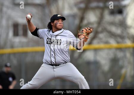 Pitcher delivering a pitch to an opposing hitter during a high school baseball game. USA. Stock Photo