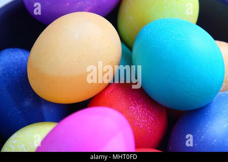 Group of eggs brightly colored for easter, in a pile, close-up