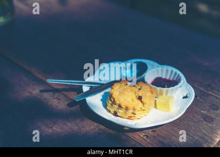 scones with clotted cream and jam, strawberries on the background, selective focus Stock Photo