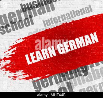 Learn German on the White Wall. Stock Photo