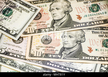 Dollar bills of different denominations background Stock Photo