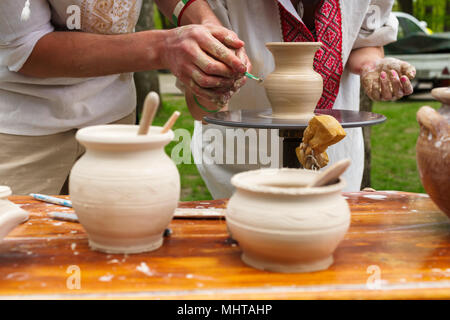 a potter shows the girl how to make a pitcher Stock Photo