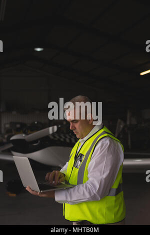 Crew member using laptop Stock Photo