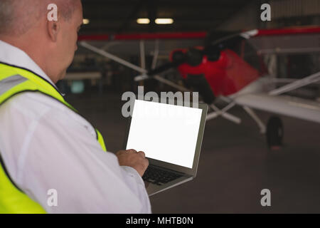 Crew member using laptop Stock Photo