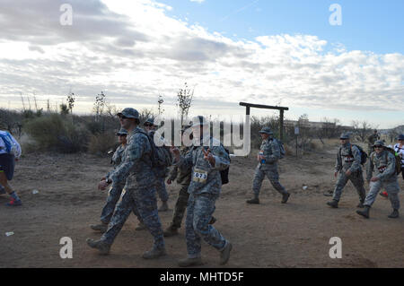 U.S. Army Reserve Soldiers with the 372nd Quarter Master Battalion (Petroleum Support), stationed at Kirtland Air Force Base, New Mexico, and 4th Sustainment Command (Expeditionary), based at Fort Sam Houston, Texas, pass check point 1 during the 2018 Bataan Memorial Death March at White Sands Missile Range, New Mexico, March 25, 2018. The Bataan memorial Death March honors the U.S. service members and Filipino Soldiers that were forced marched 65 miles by the Japanese Army through the Philippine jungle in April of 1942. Events like this challenge a Soldier’s body and mind, while ensuring Amer Stock Photo