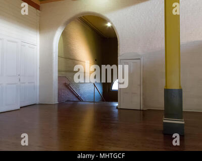 an arched stairway leading down from a large hall Stock Photo