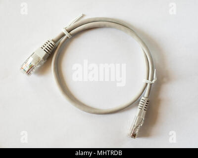 Patch cord grey network cable with molded RJ45 plug isolated on white background Stock Photo