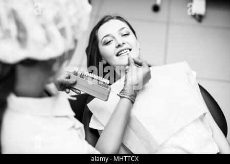 Patient's teeth shade with samples for bleaching treatment. Stock Photo