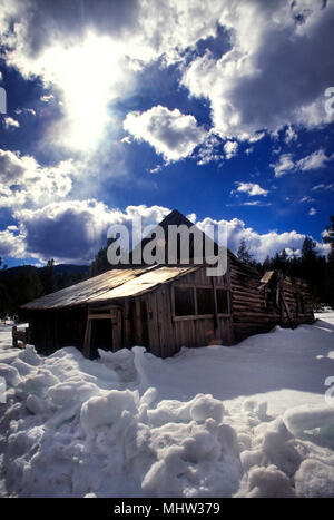 Old log cabin in winter. Idaho USA Stock Photo