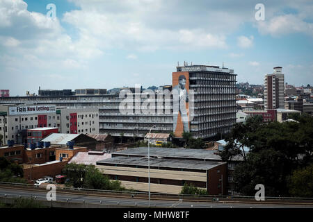 View of a building in the Central Business District of Johannesburg, South Africa with a large mural of Nelson Mandela on the exterior wall. Stock Photo