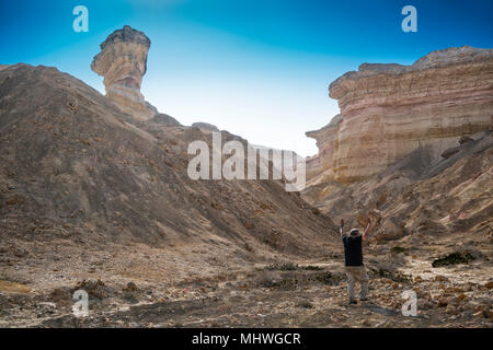 man walking in the middle of canyons in Namibe, Africa, Angola. Stock Photo