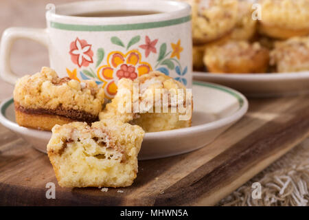 Closeup of mini cinnamon cream cheese coffee cake with a cup of coffee on a wooden tray Stock Photo