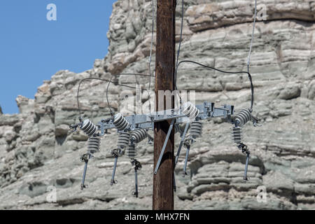 old electric power cables wire poles in the desert Stock Photo