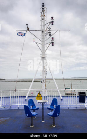 Table and chairs on the deck of a Wightlink ferry between Lymington, Hampshire and Yarmouth, Isle of Wight. Stock Photo