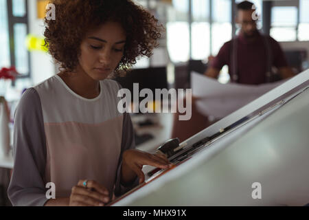 Female architect designing on drafting table Stock Photo