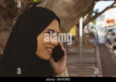 Urban hijab woman talking on mobile phone Stock Photo