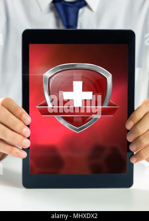 Health shield icon and hands holding tablet Stock Photo