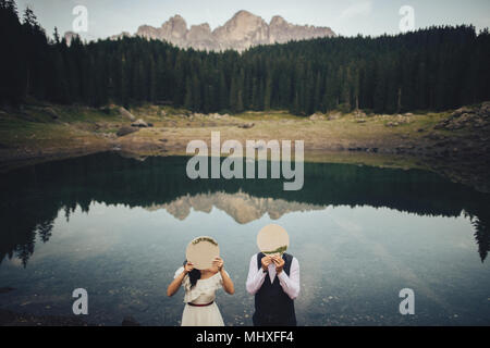young couple in love travelling, beautiful views of italian dolomites and mountain lake. Wellcome to italy Stock Photo