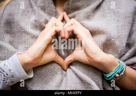 Young woman's hands making heart shape, cropped Stock Photo
