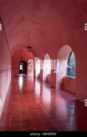 Pink corridors in colonial house. Once a palace for the elite, this is now a museum in Mexico. All corridors and rooms are painted pink Stock Photo