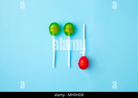 Lollipop flat lay minimal concept, three round lollipops are luing on blue background, trendy pop art style photo, isolated Stock Photo