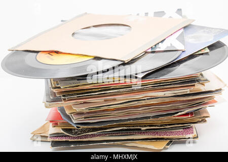 A stack of seven inch 45rpm vinyl singles mostly with songs from the 1980s that have been stored in a loft from a record collection. Dorset England UK Stock Photo