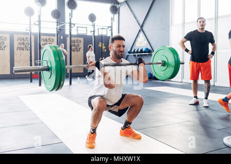 Man weightlifting barbell in gym Stock Photo