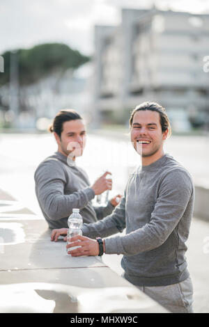 Young adult male twins taking a training break, portrait Stock Photo