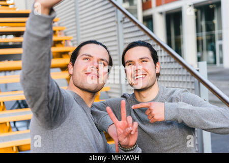 Young adult male twins training together, taking self  portrait Stock Photo