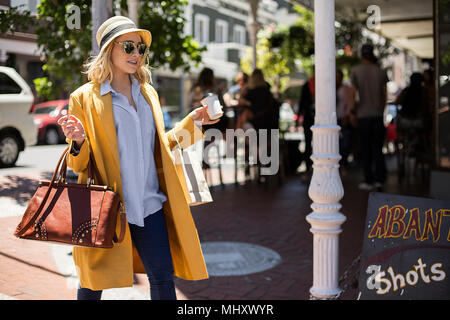 Woman passing restaurant, Cape Town, South Africa Stock Photo