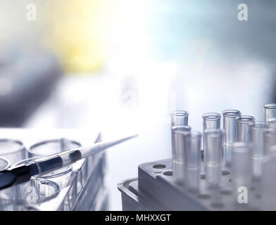 Pipette on multi well plate with pipette tips during an experiment in the laboratory, close-up Stock Photo