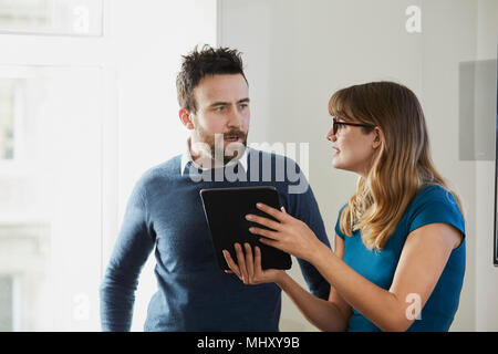 Colleagues in office using digital tablet Stock Photo
