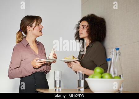 Colleagues taking a break, having lunch, chatting Stock Photo