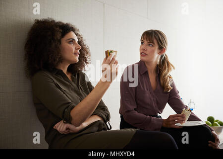 Colleagues taking a break, having lunch, chatting Stock Photo
