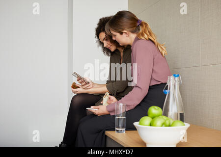 Colleagues taking a break, having lunch, chatting Stock Photo
