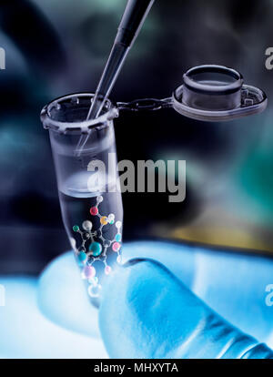 Scientist pipetting sample into vial with molecular structure of formula Stock Photo
