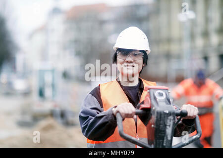 Young construction worker wearing hard hat Stock Photo