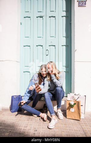 Friends taking selfie on doorstep Stock Photo