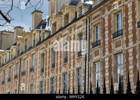 Elegant rooftops and windows adorn the buildings at Place des Vosges in The Marais district of Paris,one of the most beautiful squares in Paris Stock Photo