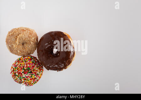 donuts of various size color and shape.  copy space in frame. Stock Photo
