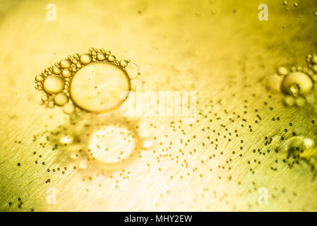 Oil drops and bubbles on a metal gear engine surface. Closeup photo. Stock Photo