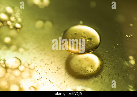 Oil drops and bubbles on a metal gear engine surface. Closeup photo. Stock Photo