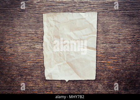 crumpled paper on wood texture and background with copy space. Stock Photo