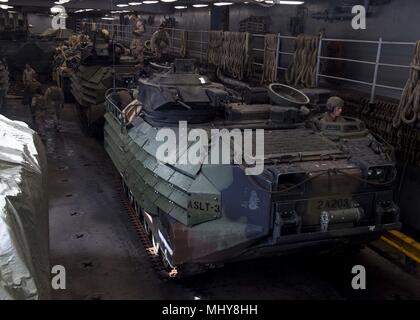 180430-N-TJ319-0251 AQABA, JORDAN (April 30, 2018) AAV-P7/A1 assault amphibious vehicles, attached to the 26th Marine Expeditionary Unit, enter the vehicle storage area aboard the Harpers Ferry-class dock landing ship USS Oak Hill (LSD 51) April 28, 2018, April 30, 2018. Oak Hill, home-ported in Virginia Beach, Virginia, is in the U.S. 5th Fleet area of operations participating in Eager Lion, a capstone training engagement that provides U.S. forces and the Jordan Armed Forces an opportunity to rehearse operation in a coalition environment and to pursue new ways to collectively address threats  Stock Photo