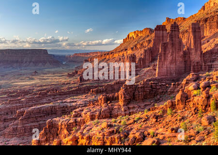 Fisher Towers rock formations rise above the Colorado River in Professor Valley in the late afternoon sun near Moab, Utah. Stock Photo