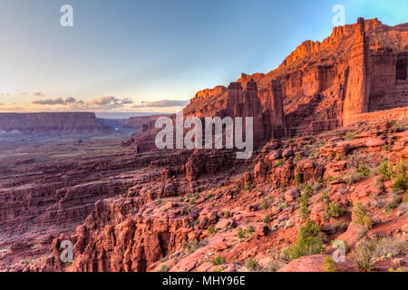 Fisher Towers rock formations rise above the Colorado River in Professor Valley in the early evening light near Moab, Utah. Stock Photo