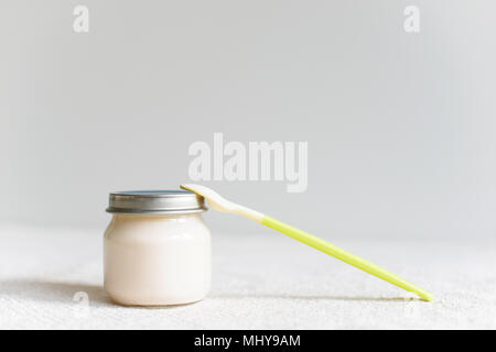 Bowls of pureed food with spoon for baby over blurred background with free copy space Stock Photo