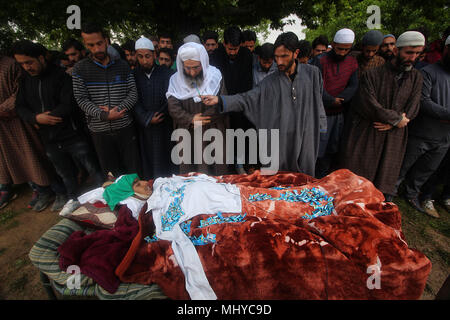 Shopian, India. 03rd May, 2018. (EDITORS NOTE: Image depicts death) School shirt is placed on the body of a teenager, Umar Kumar as people offer funeral prayer in Pinjoora some 50 kilometers from Srinagar the summer capital of Indian controlled Kashmir on May 03, 2018. Umar was shot dead by government forces after the clashes erupt following a gun battle between rebels and Indian forces in Turkewangam area of south Kashmir's Shopian. Later the rebels managed to escape from the site of gun-battle, local residents said. Credit: Faisal Khan/Pacific Press/Alamy Live News Stock Photo